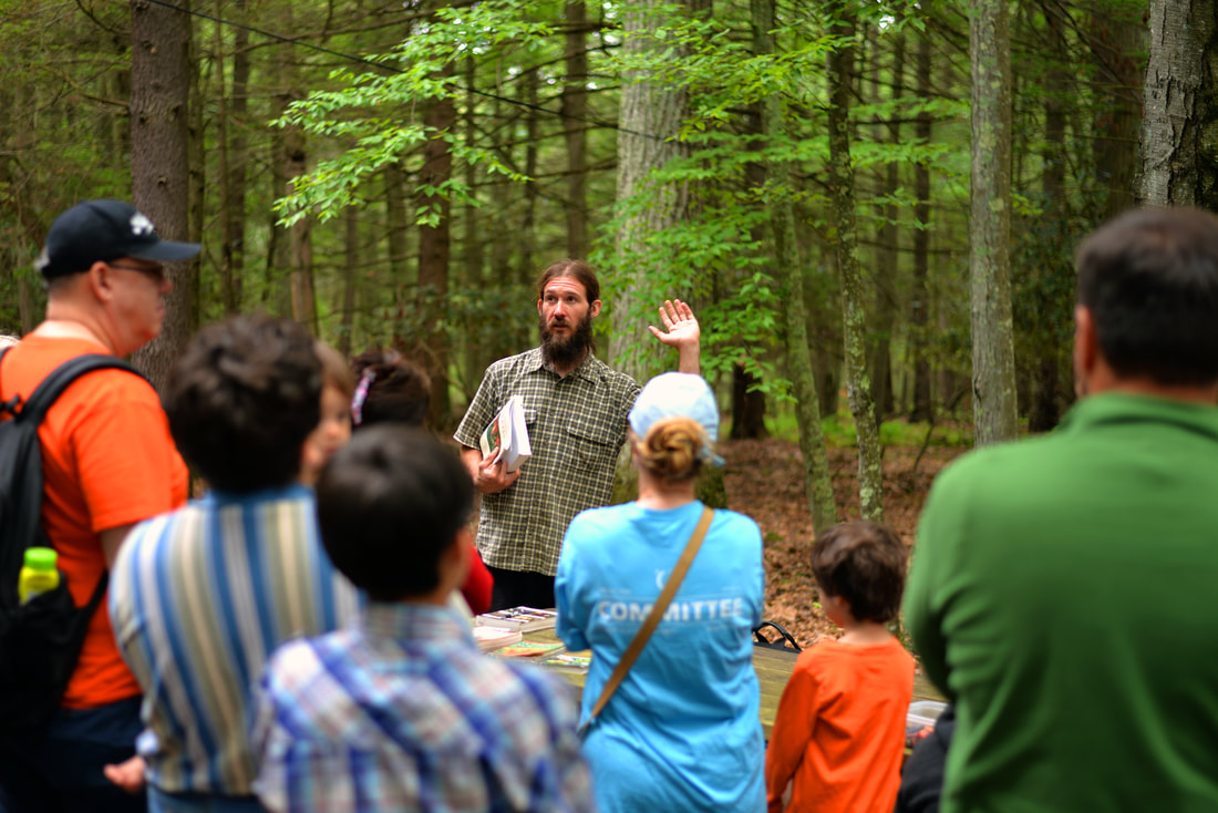 Instructor teaching a group of kids outside at Lacawac Sanctuary
