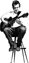 Jon-on-stool Jonathan D. Krist sitting on a stool playing guitar