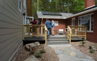 Attendees standing outside on the deck.