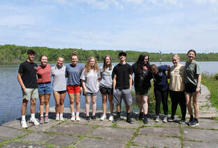 Group of students standing along side of Lake Lacawac