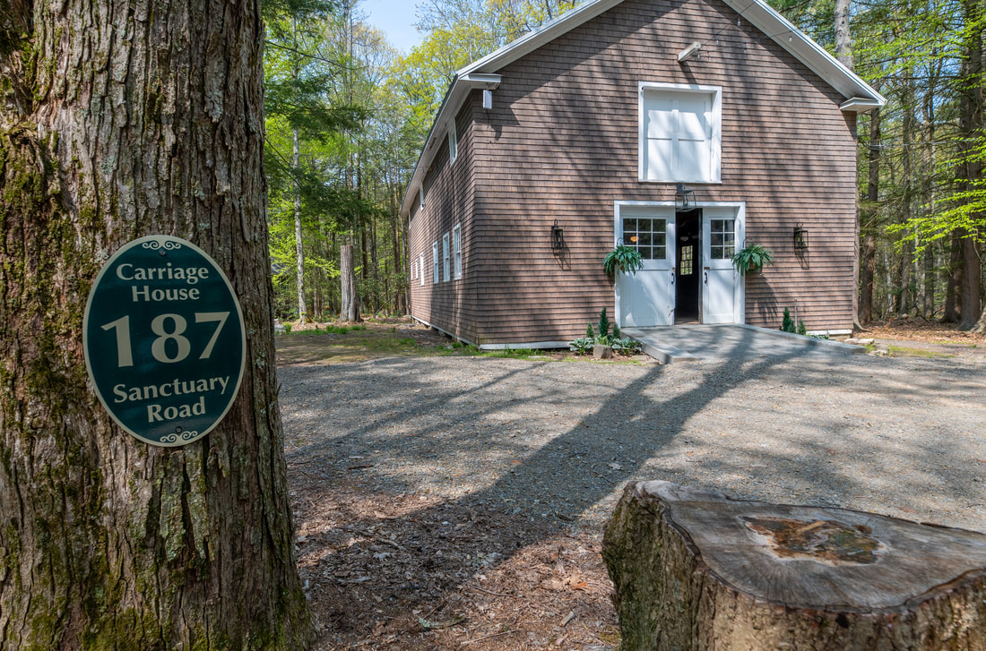 Outside view of Carriage House with address marker: 187 Sanctuary Road